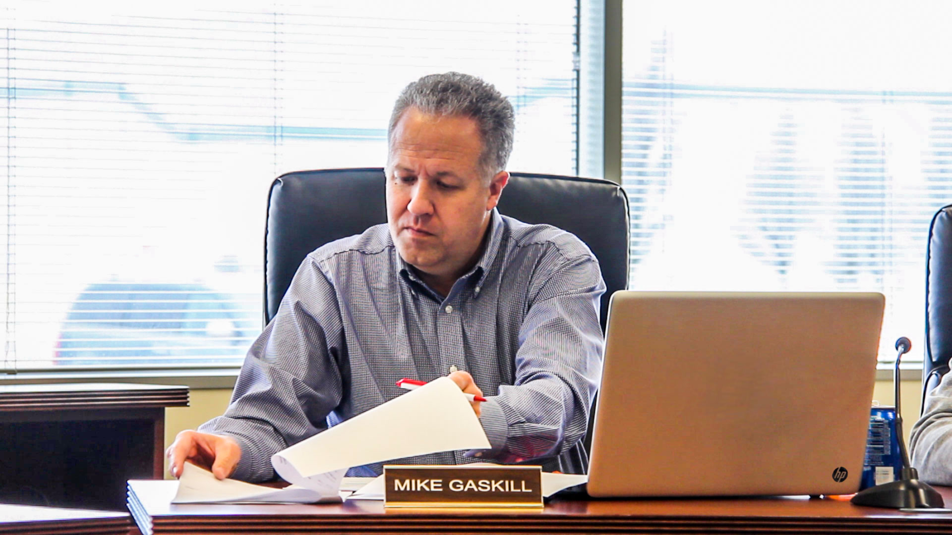 Mike Gaskill working at his Senate desk beside his nameplate